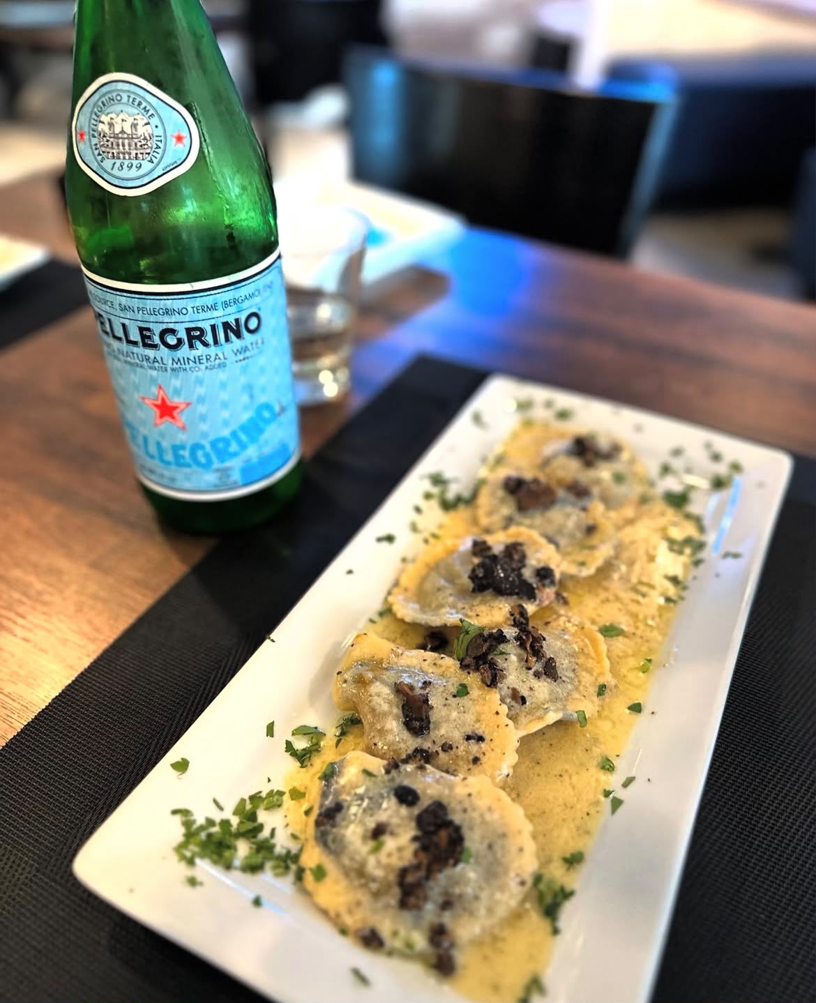 Ravioli with truffle cream served with San Pellegrino